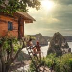 couple sitting on brown wooden ladder