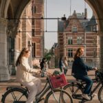 women on bicycles on the streets of amsterdam the netherlands