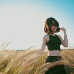 woman on wheat field during daytime