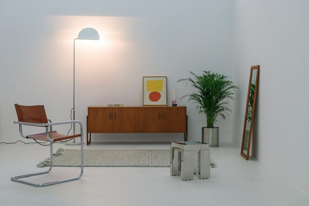 A white room with a chair and a lamp