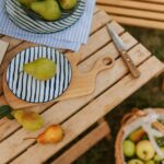 A wooden table topped with bowls of fruit