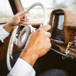 person holding vehicle steering wheel