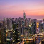 Captivating view of Dubai's skyline at dusk with vibrant city lights and skyscrapers.