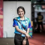 smiling girl standing near building