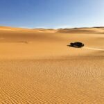 black car on desert during daytime