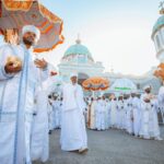 Orthodox religious procession at a church in Addis Ababa, Ethiopia, showcasing traditional attire and rituals.