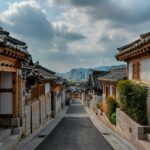 a street lined with wooden buildings under a cloudy sky
