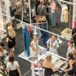 group of people gather in clothes stores
