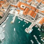 aerial photography of boats on pier and city