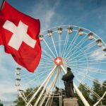 a large ferris wheel sitting next to a statue