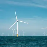 a group of wind turbines in the ocean