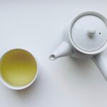 white ceramic teapot beside white ceramic mug