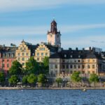 Charming view of colorful historic buildings along Stockholm's waterfront on a sunny day.